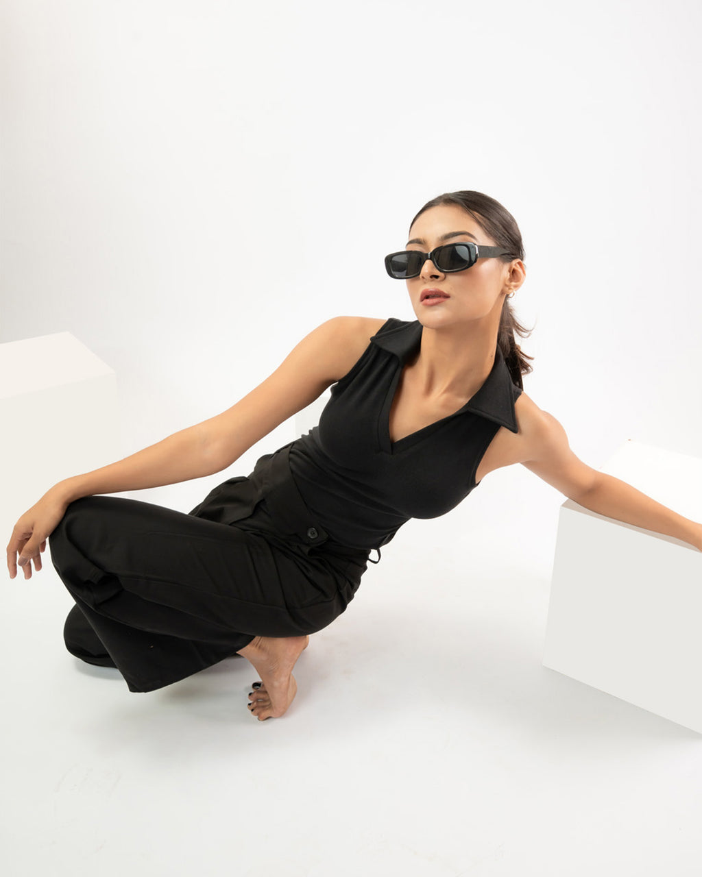 Women’s sleeveless polo top in rib knit black fabric, minimal everyday styling
