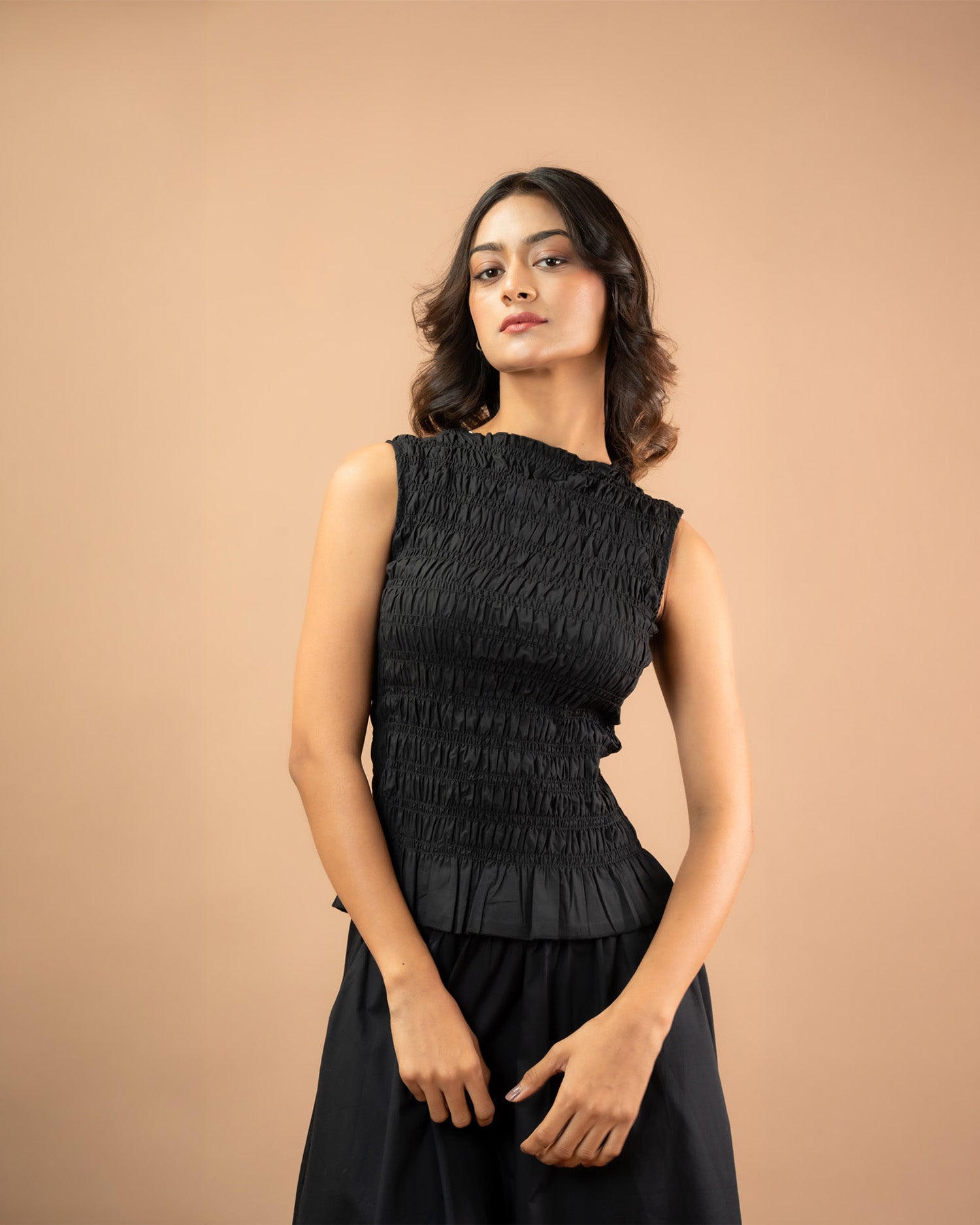 Women’s smocked top with peplum hem, sleeveless casual and comfortable styling