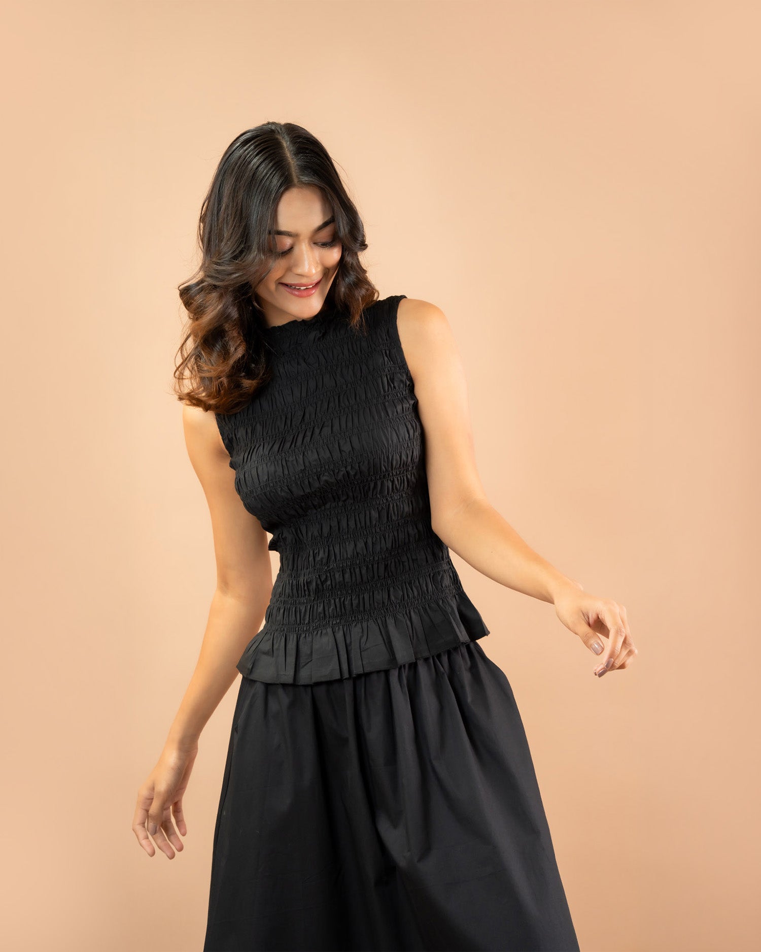 Flattering smocked sleeveless peplum top for women, minimal everyday fashion