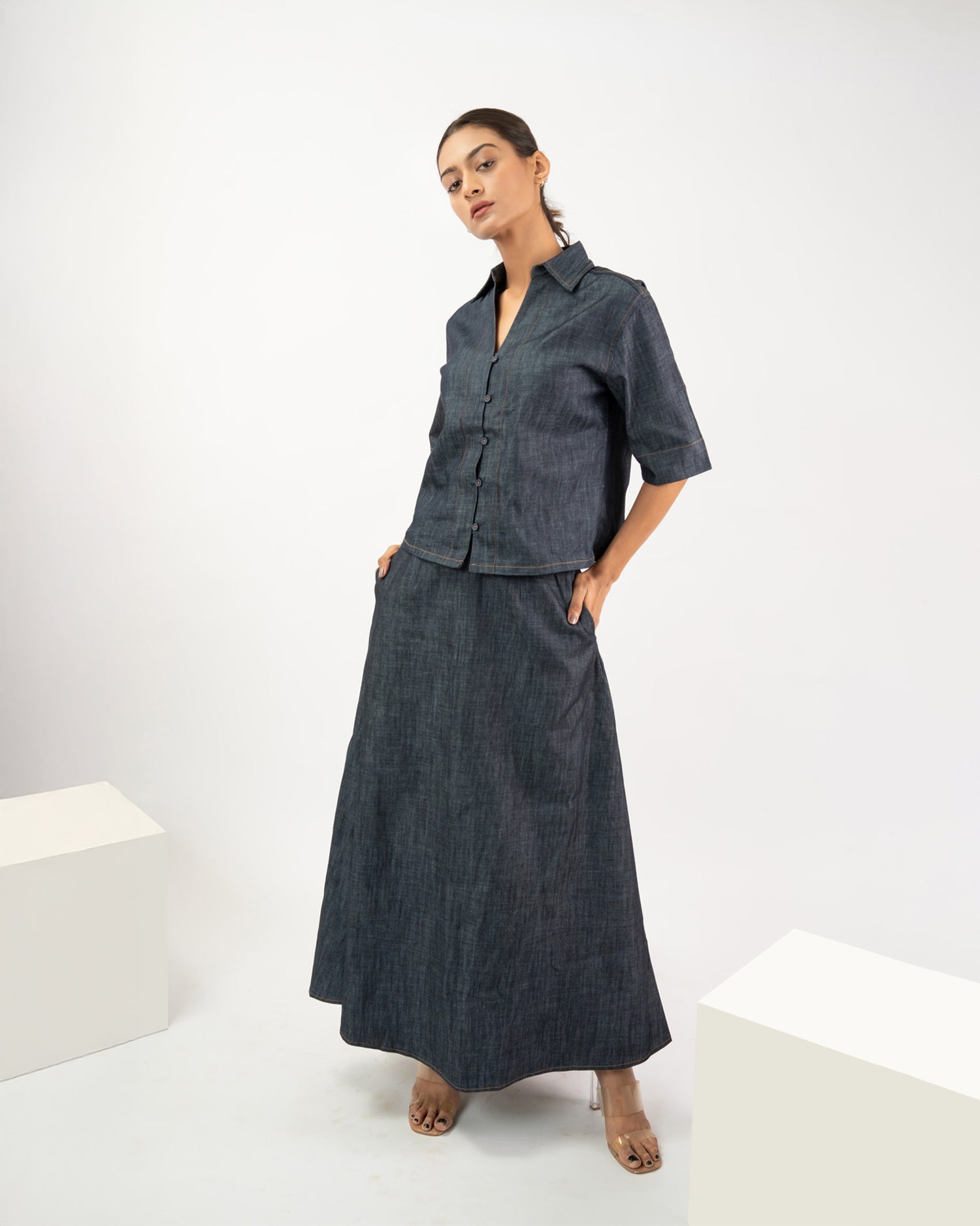 Minimal women’s denim co-ord set, flared maxi skirt and relaxed fit shirt styling