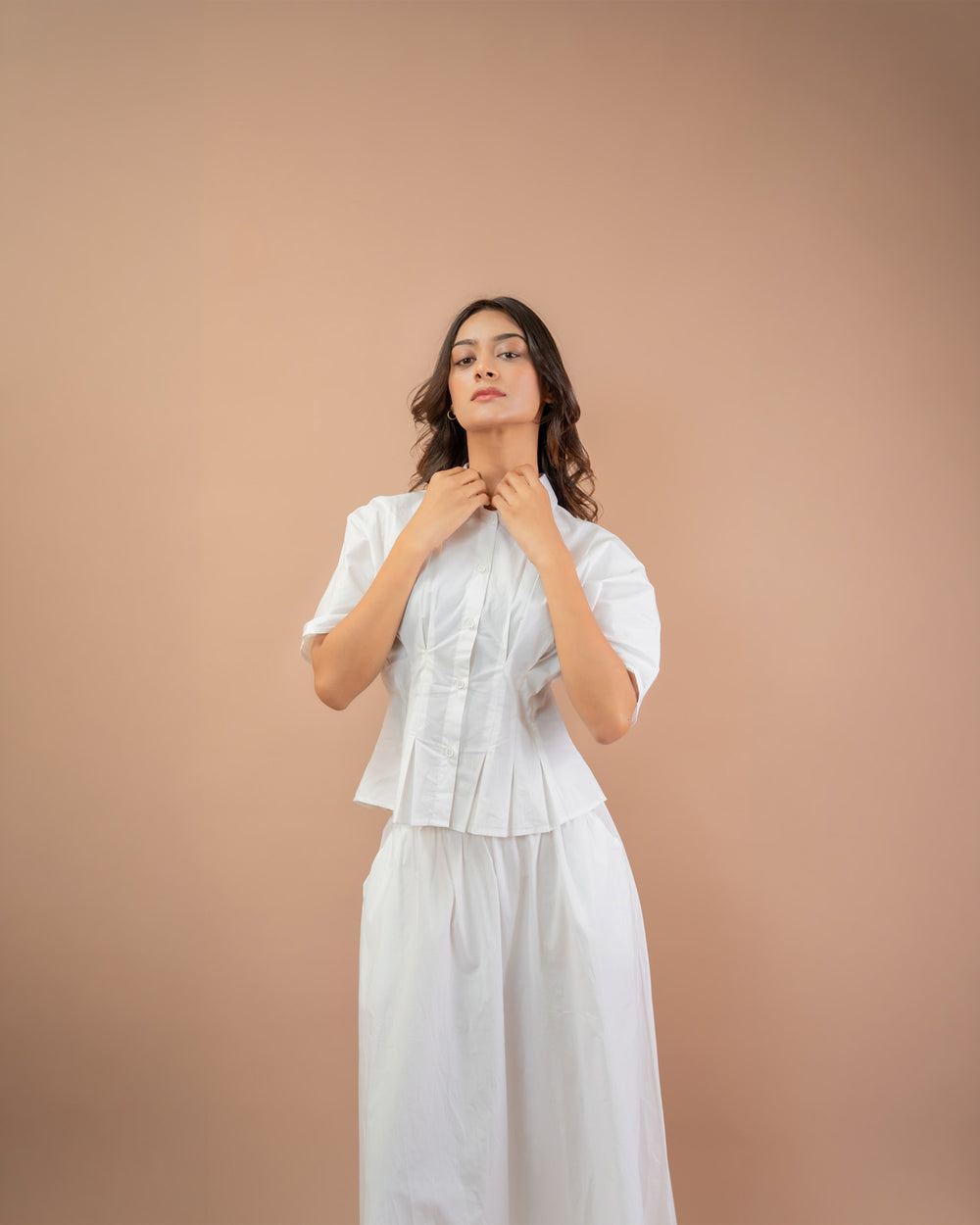 Minimal women’s co-ord set white pleated shirt and long flared skirt, summer styling