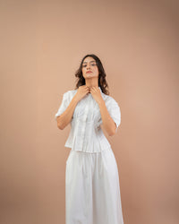 Minimal women’s co-ord set white pleated shirt and long flared skirt, summer styling